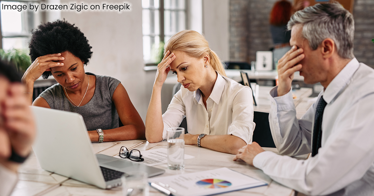 frustrated business team sitting around table