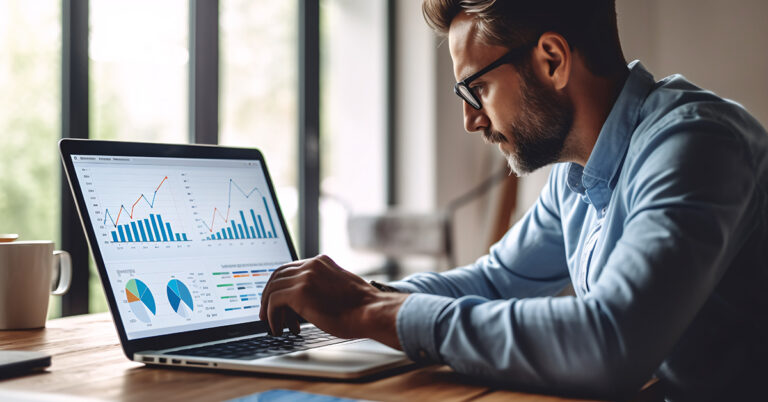 Business professional examining data on a laptop