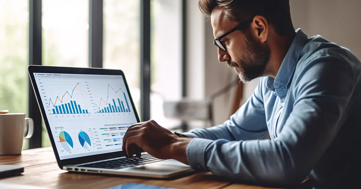 Business professional examining data on a laptop