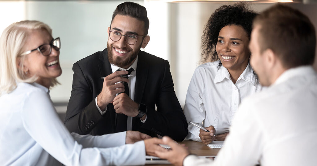 Diverse team members pay attention to veteran business team leader