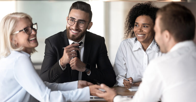 Diverse team members pay attention to veteran business team leader